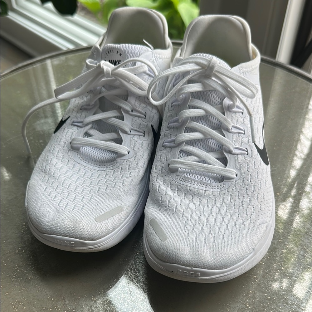 White Athletic Sneakers with Black Swoosh. Very nice,gently used Nike Free shoes